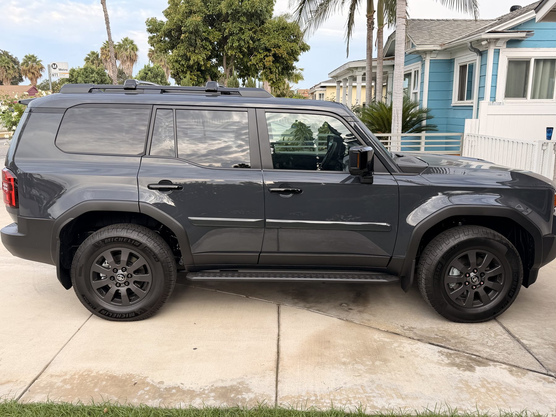 Gray Toyota SUV in a driveway before tinting, its side windows still clear factory glass with the seats and headrests plainly visible through them